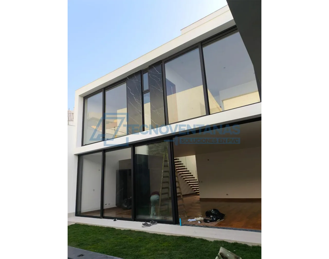 Fachada con ventanería PVC oscura de gran formato